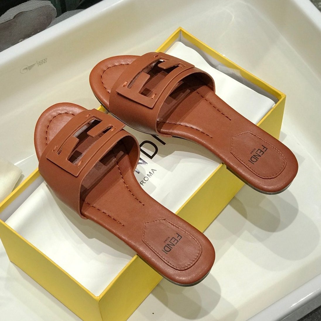 Luxury FendiLuxury FendiBAGUETTE SLIDES IN CINNAMON BROWN LAMBSKIN