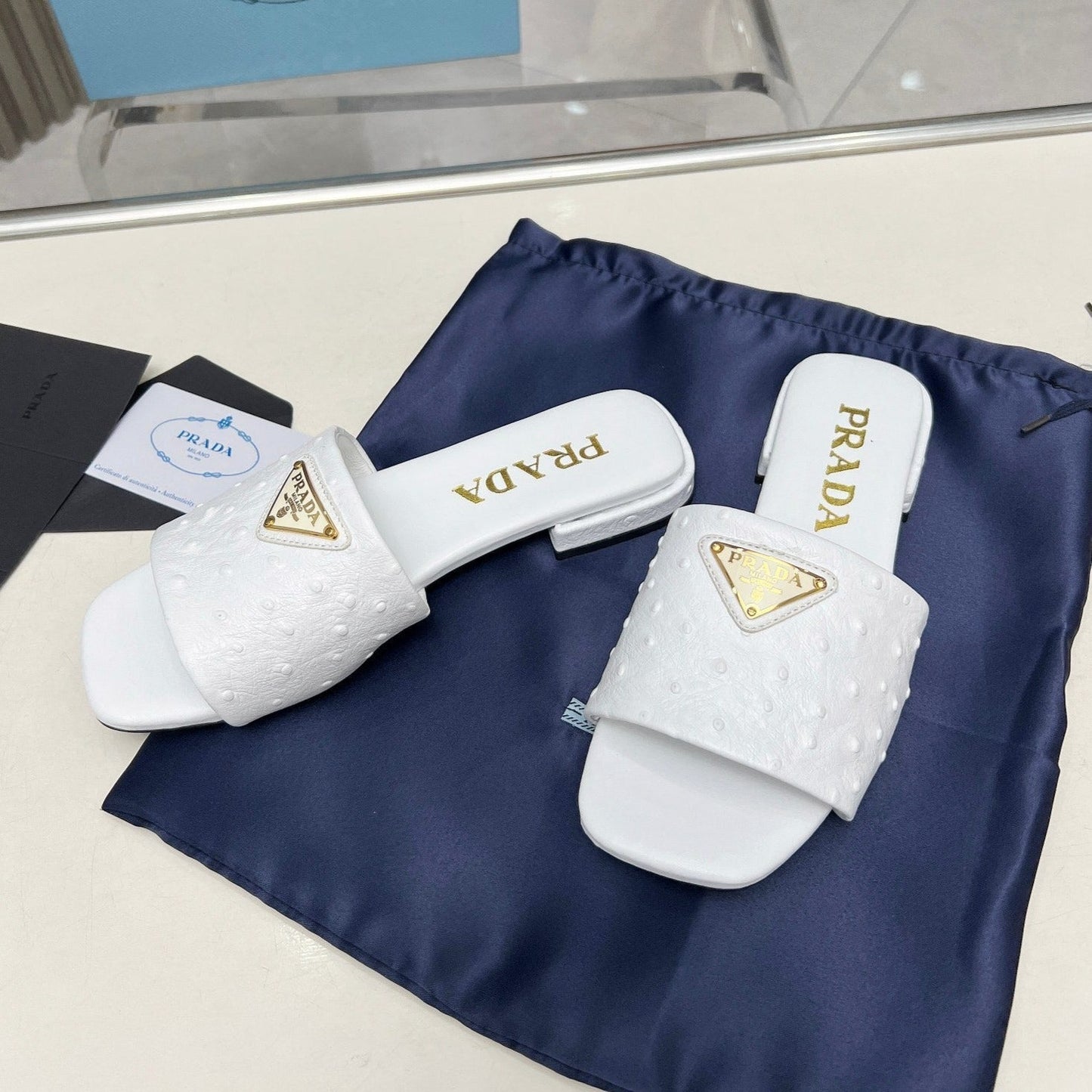 Luxury PradaSAFFIANO PATENT SLIDES OSTRICH MOTIF WHITE CALFSKIN