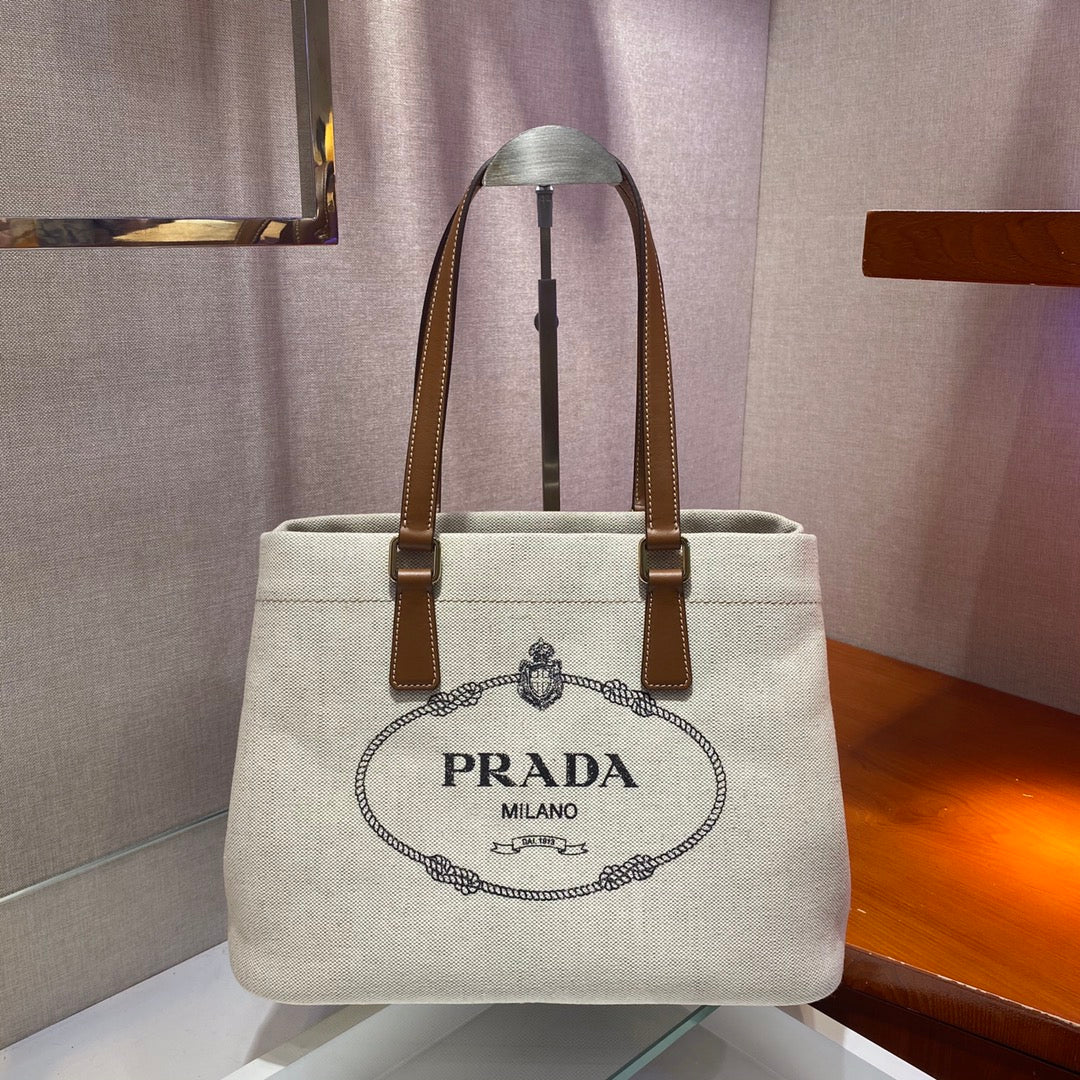 Luxury PradaTOTE BAG 33 IN WHITE CANVAS AND BROWN CALFSKIN HANDLE