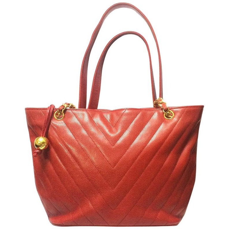 Luxury Chanel Vintage red caviarskin v stitch, chevron style chain shoulder tote bag with golden CC ball charm
