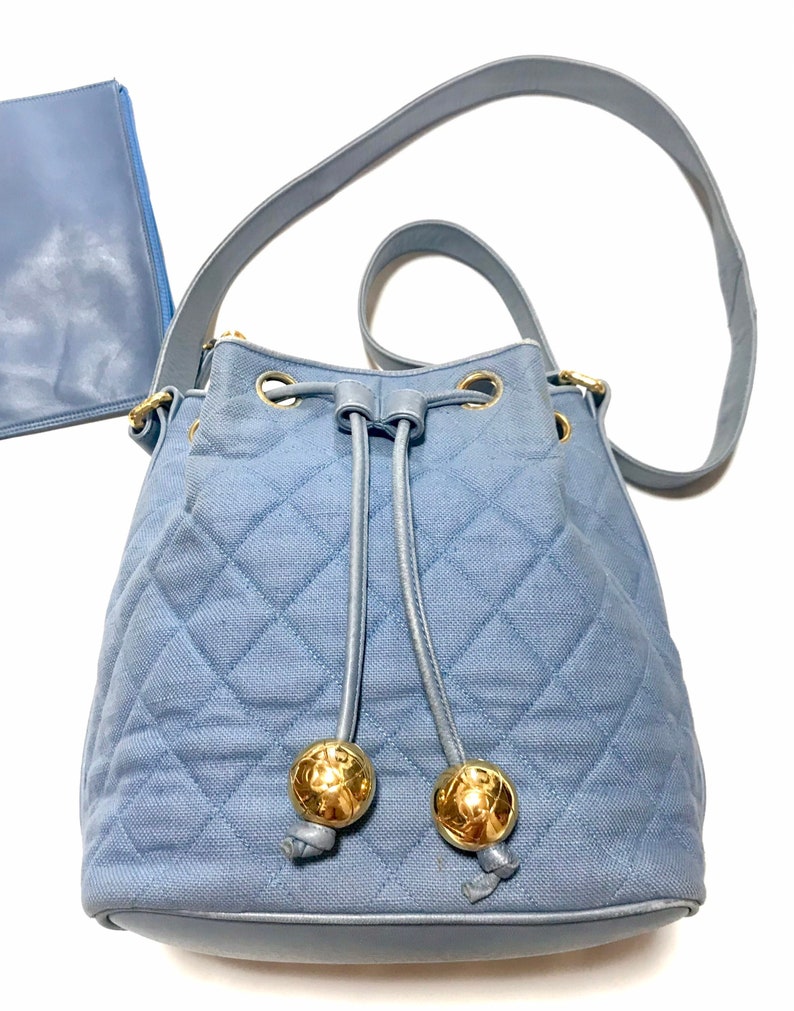 Luxury Chanel Vintage blue quilted canvas and leather combo hobo bucket shoulder bag with drawstrings and golden CC mark balls