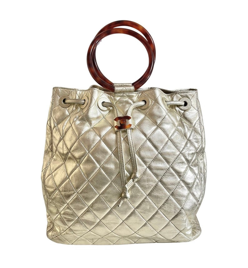 Luxury Chanel Vintage campaign gold lamb leather hobo bucket bag with marble hoop handles and turn lock CC
