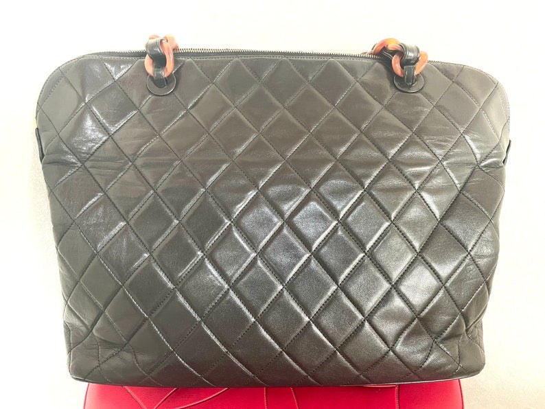 Luxury Chanel Vintage black lambskin large tote bag with brown plastic chains and CC mark charm to the LAMPO zipper